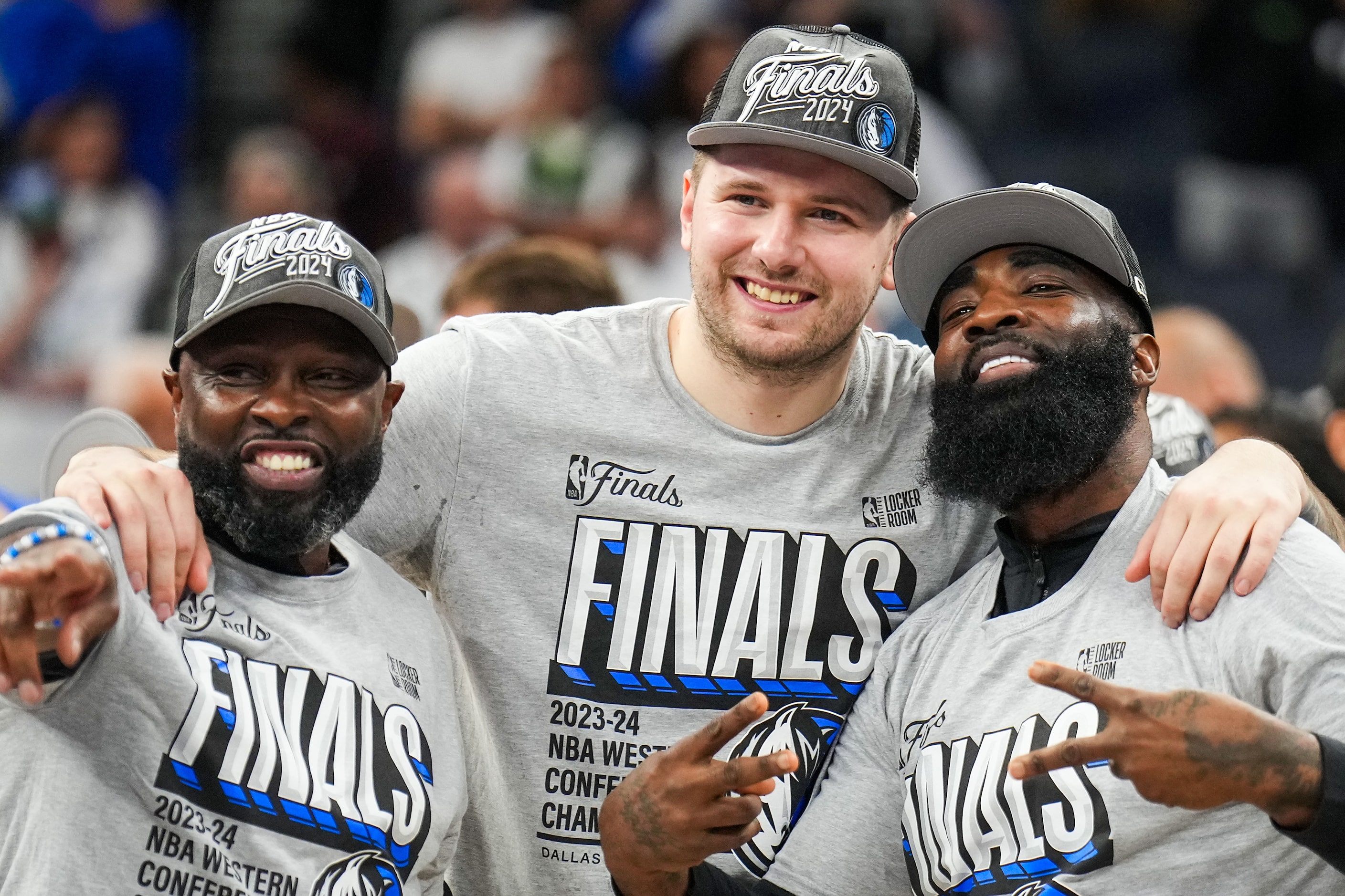 Dallas Mavericks guard Luka Doncic (center) celebrates with assistant coaches Darrell...