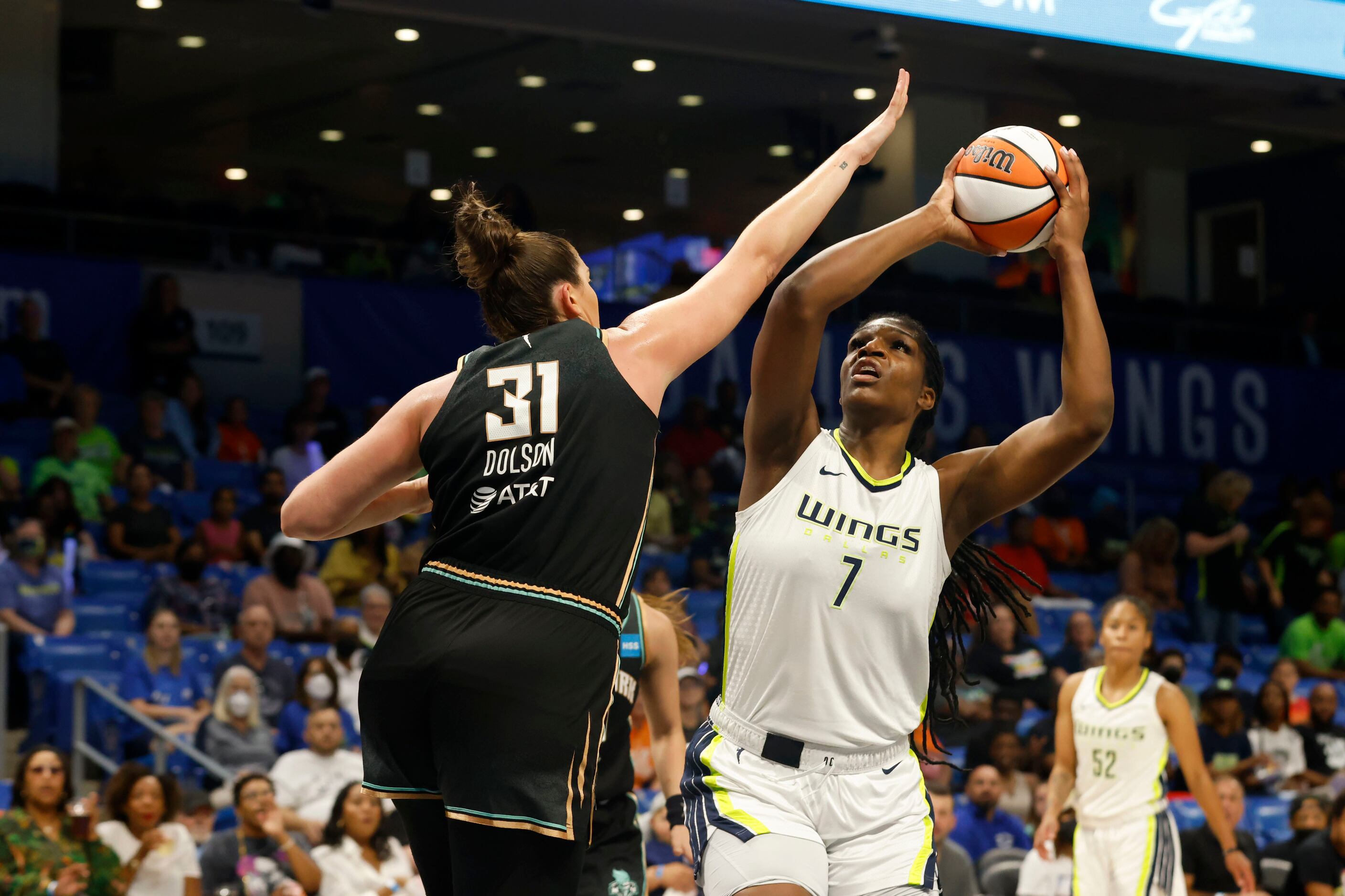 Dallas Wings center Teaira McCowan (7) shoots as she is defended by New York Liberty center...