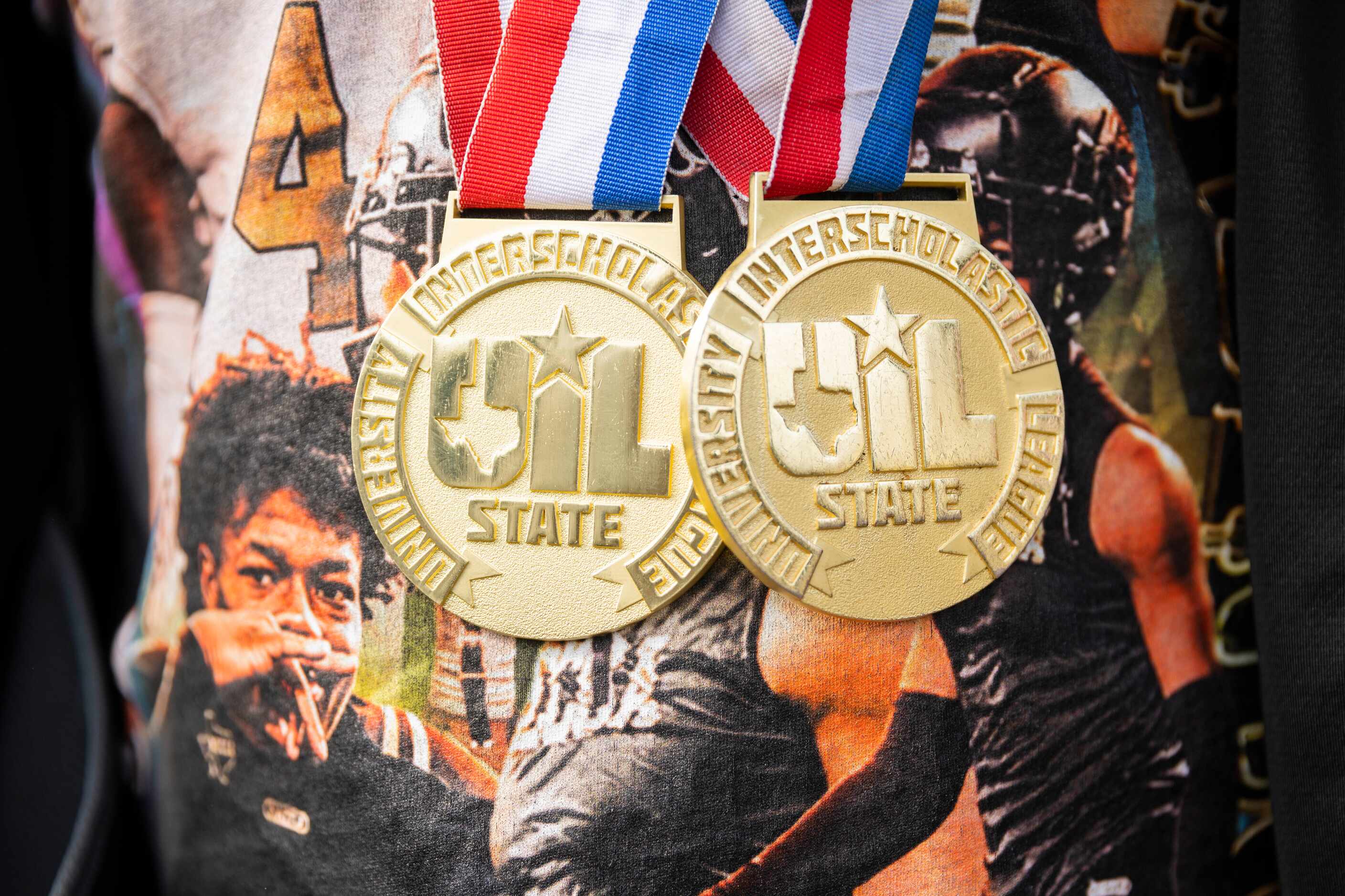 A South Oak Cliff Golden Bears football player wears his two state medals during a...