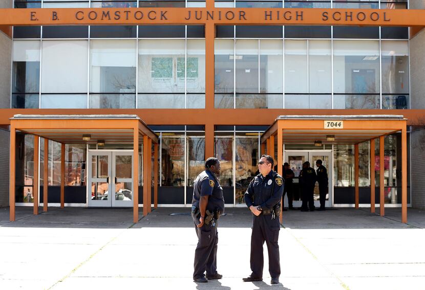Dallas ISD police officers guard the front of E.B. Comstock Middle School in southeast...