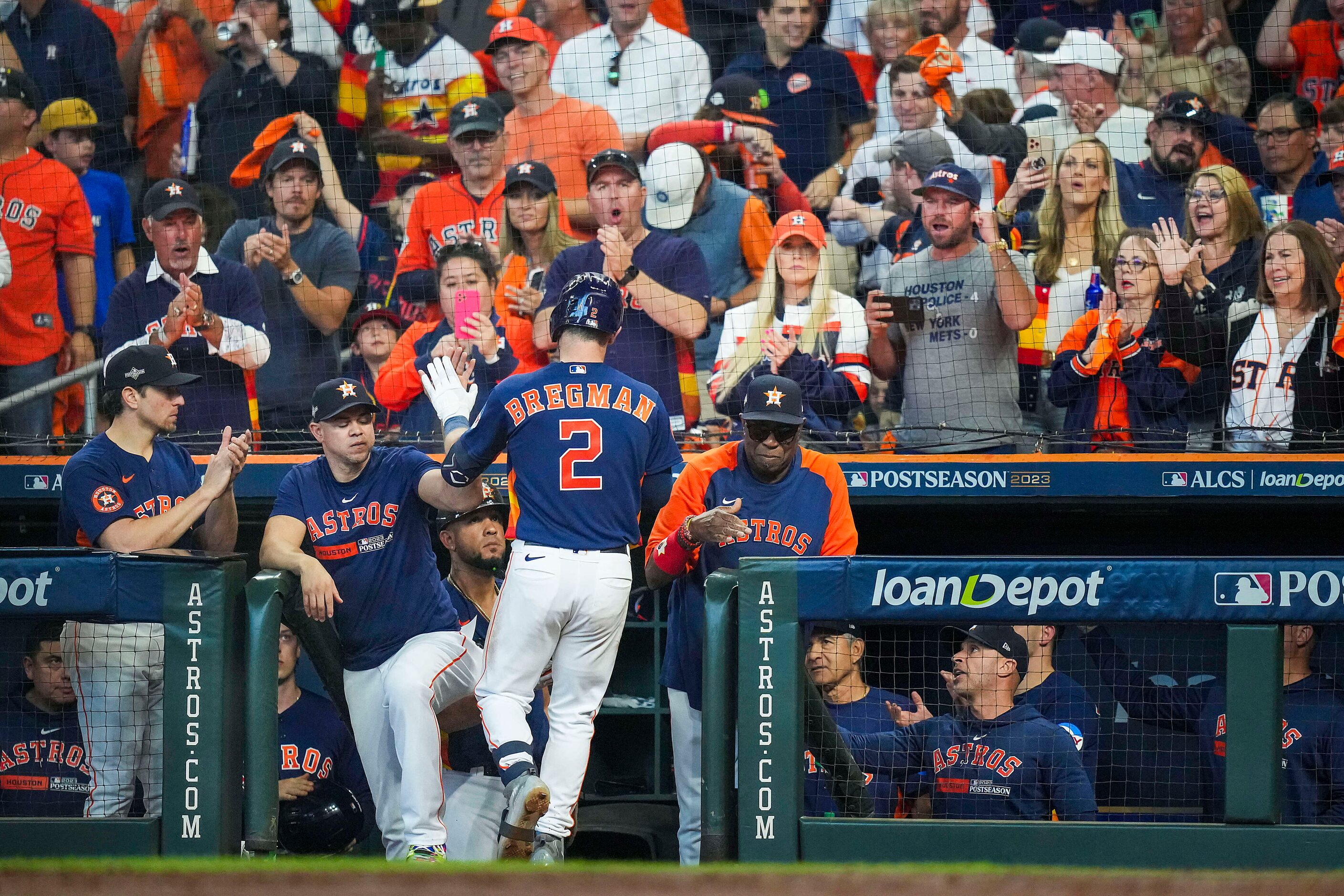 Houston Astros third baseman Alex Bregman celebrates on his way back in to the dugout after...