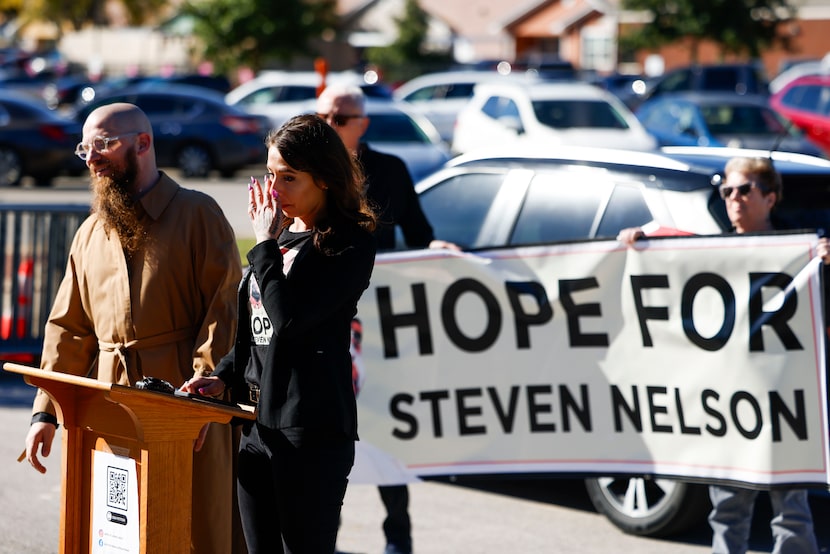 Hélène Noa Dubois, (right) partner of death row inmate Steven Lawayne Nelson, wipes off a...