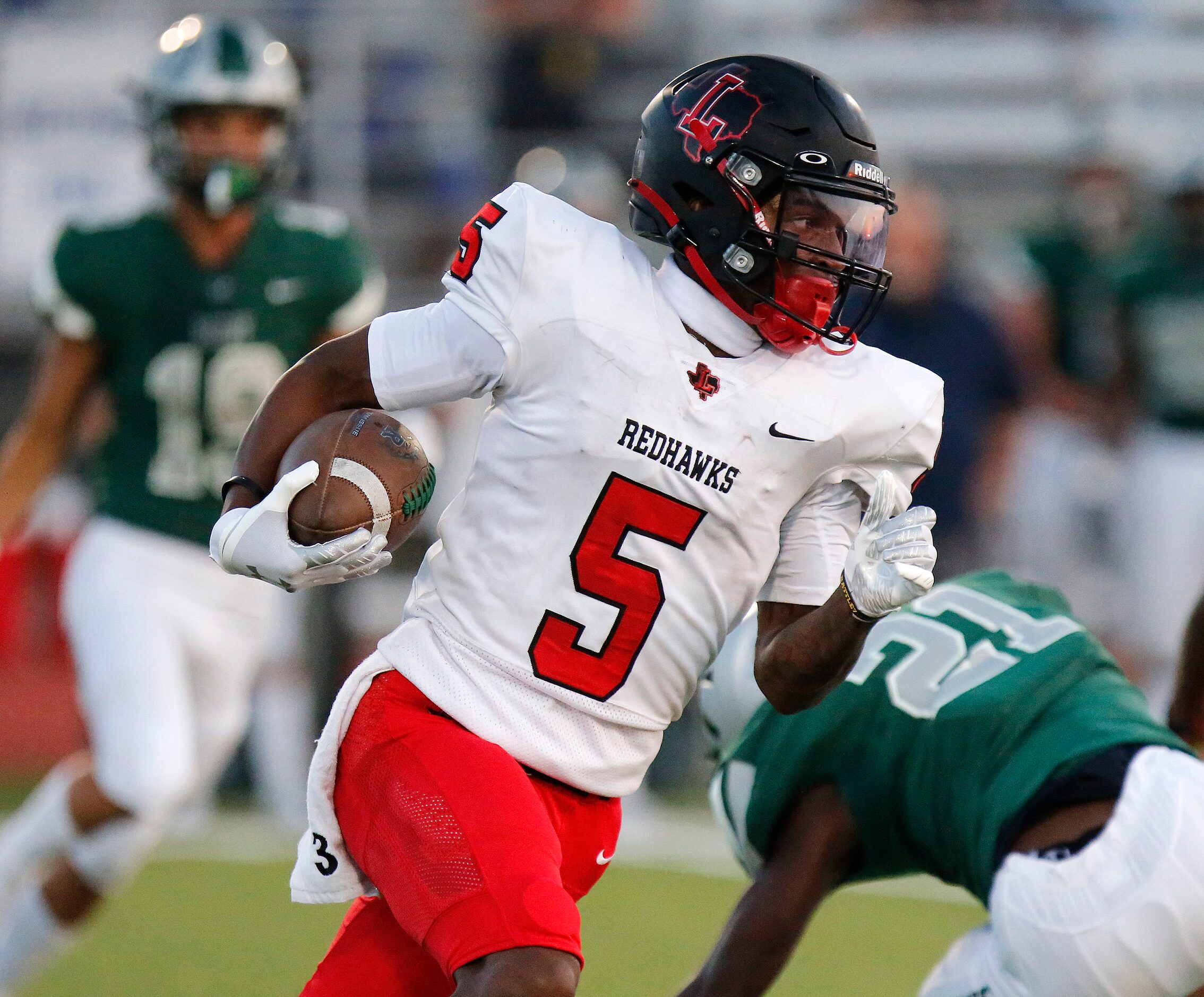 Liberty wide receiver Evan Stewart (5) carries the football during the first half as Reedy...