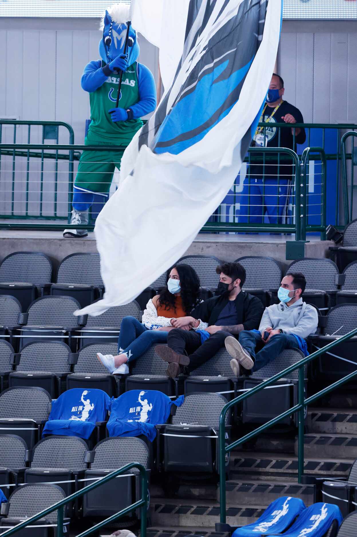 Dallas Mavericks mascot Champ waves the flag in front of  fans in attendance before the...