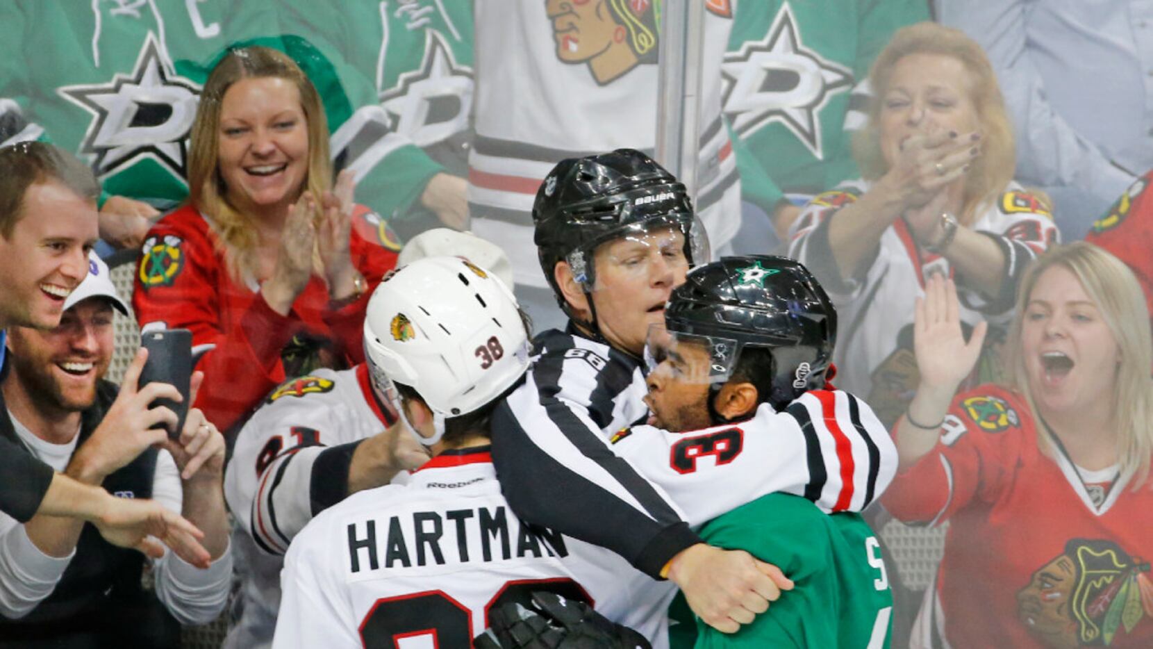 Fans enjoy getting an up close look at the skirmish between Dallas Stars center Gemel Smith...