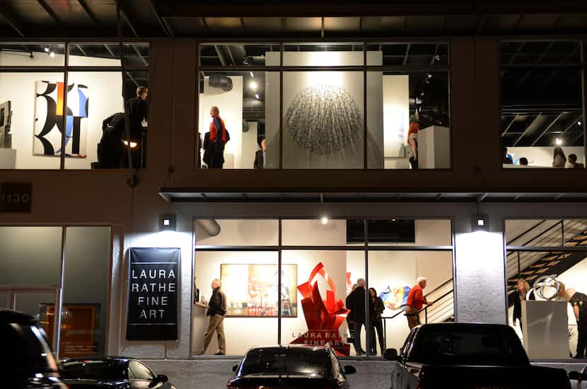 Art goers mingle and look at art in the Laura Rathe Fine Art gallery on Dragon Street. Art...