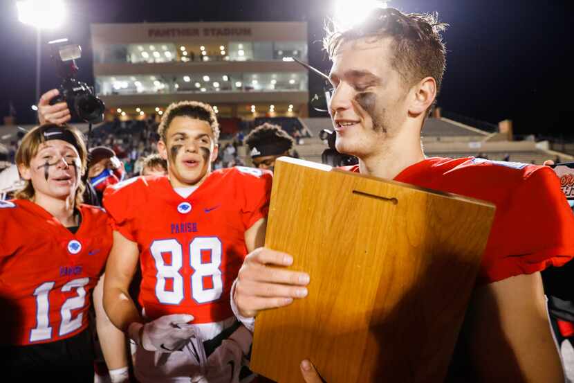 Quarterback Preston Stone holds the plaque after Parish Episcopal won the TAPPS Division I...