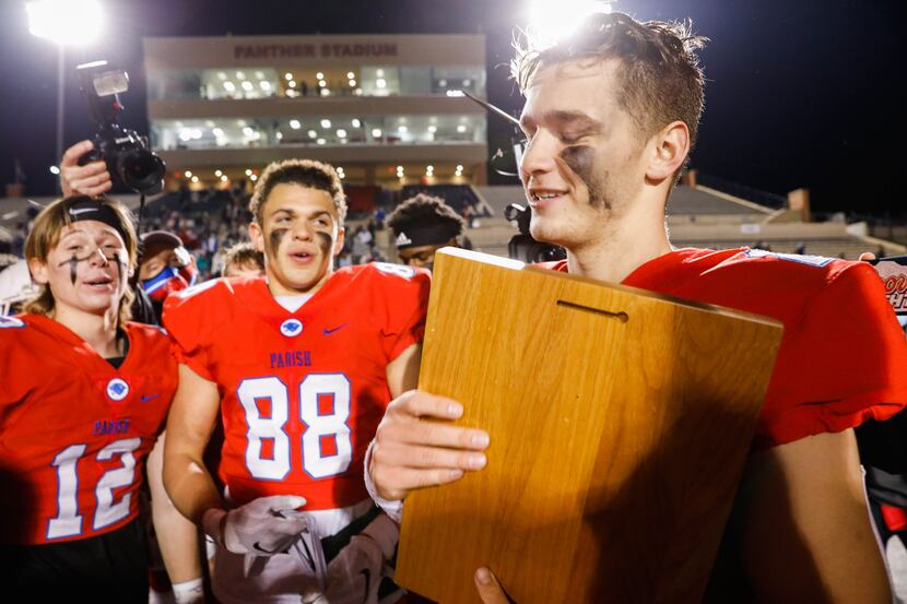 Quarterback Preston Stone holds the plaque after Parish Episcopal won the TAPPS Division I...