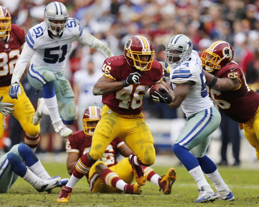 Washington Redskins running back Alfred Morris (46) runs past Dallas Cowboys defensive end...