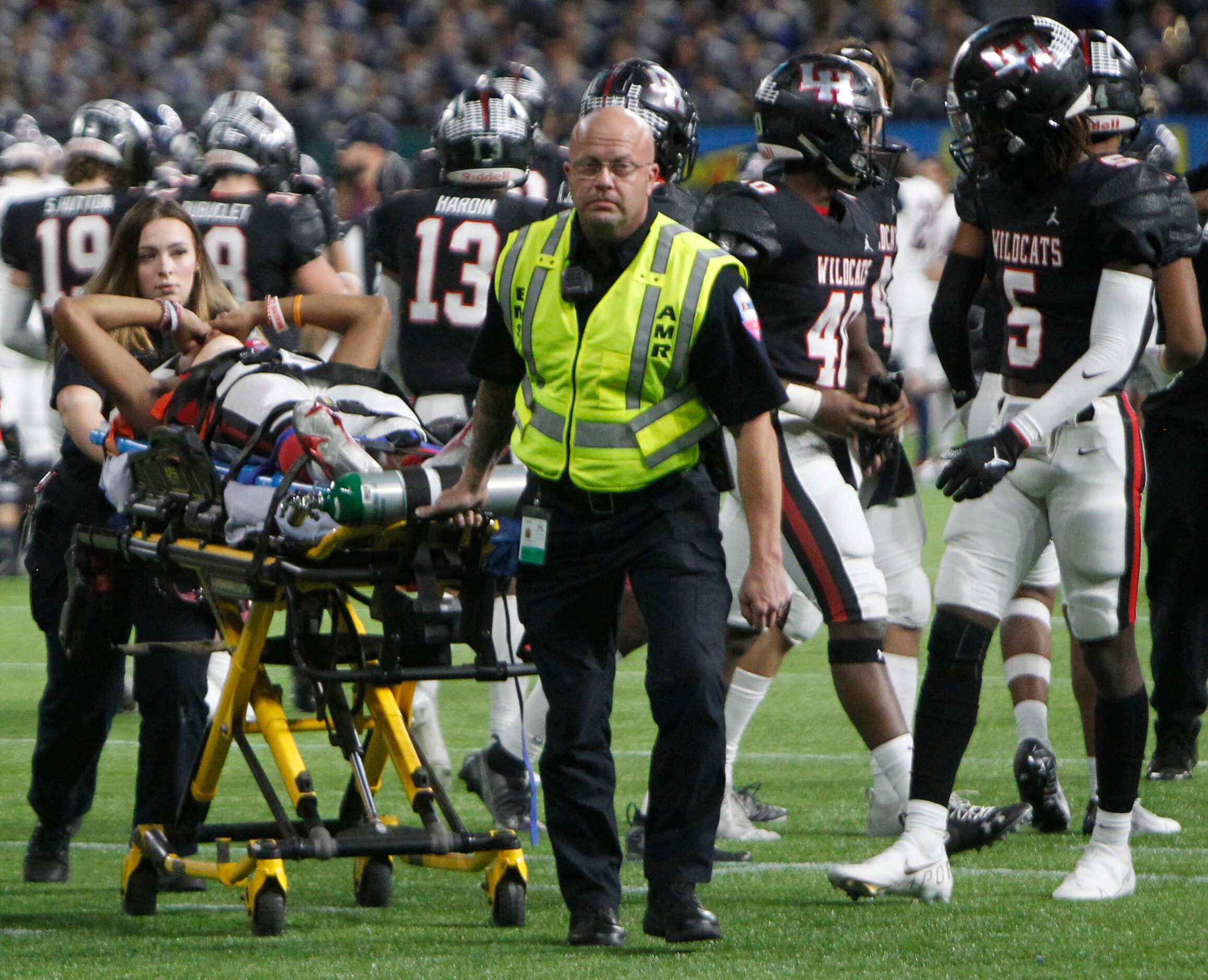 Arlington Fire Department medical personnel assist Lake Highlands defensive back Shamar...