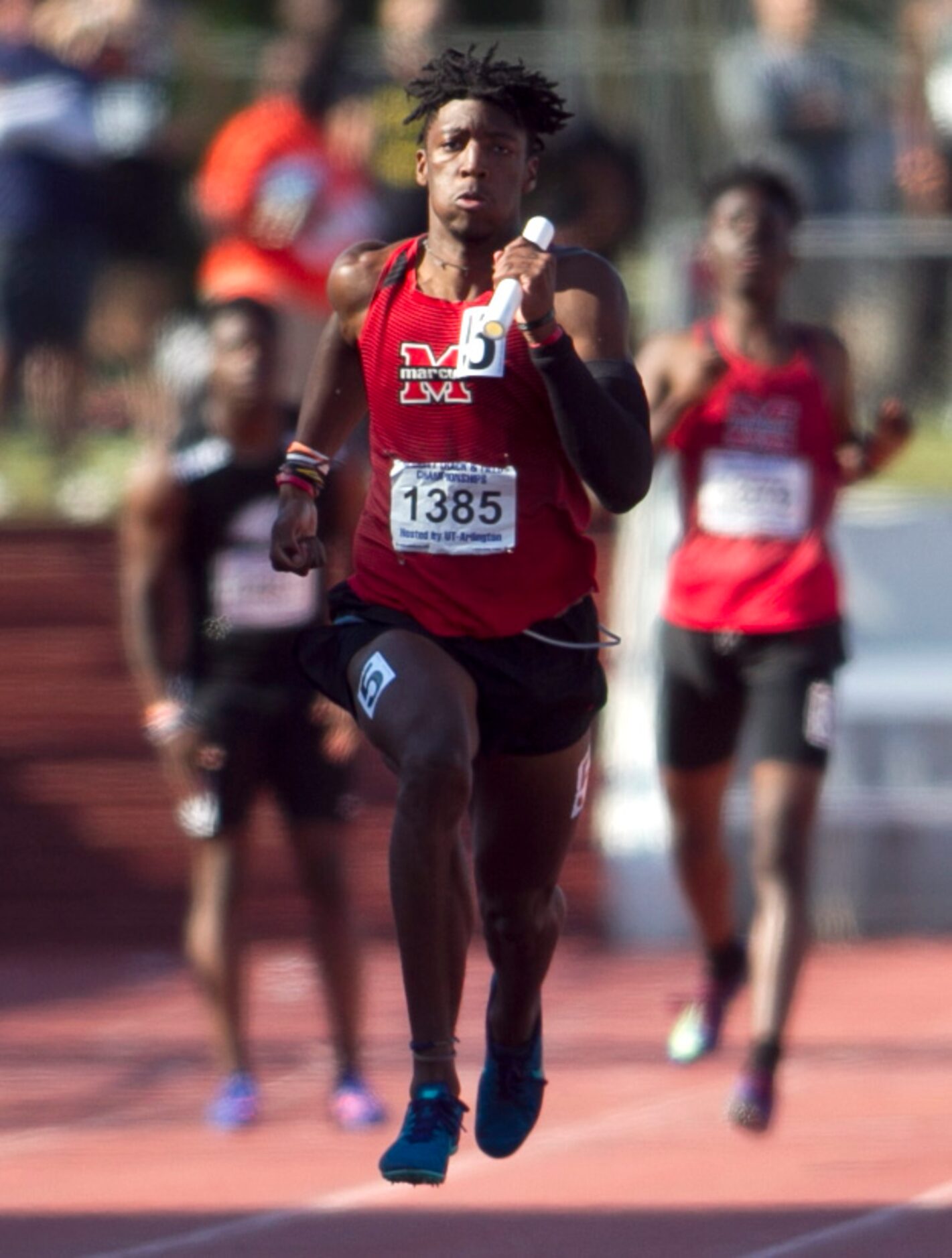 Flower Mound Marcus sprinter Michael Sturdivant carries the baton for the final leg to a...