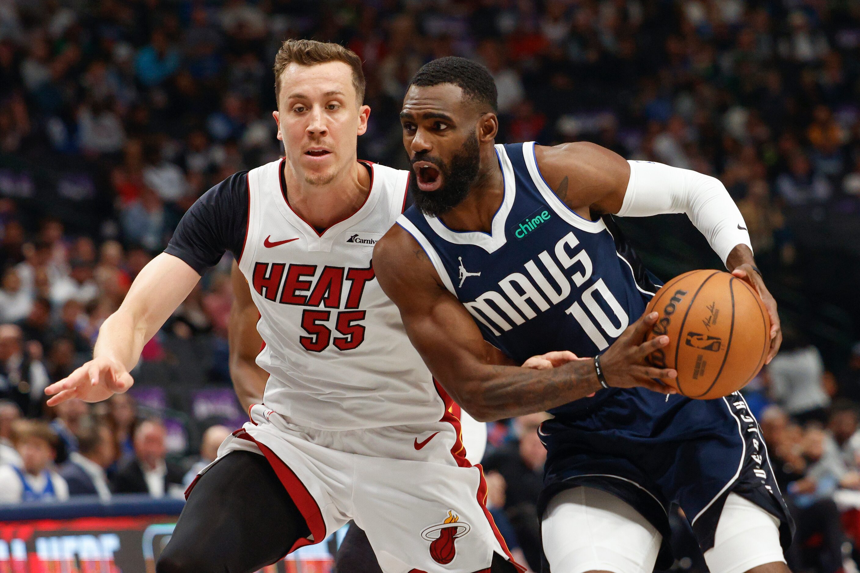 Dallas Mavericks guard Kyrie Irving (11) drives to the basket against Miami Heat forward...