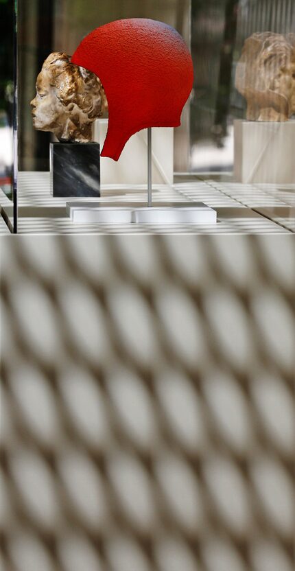 Shadows obscure the work of several sculptors as the reflected light from Museum Tower casts...