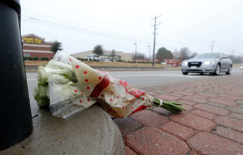 White roses were left on Custer Road in McKinney near the scene of Saturday evening's plane...