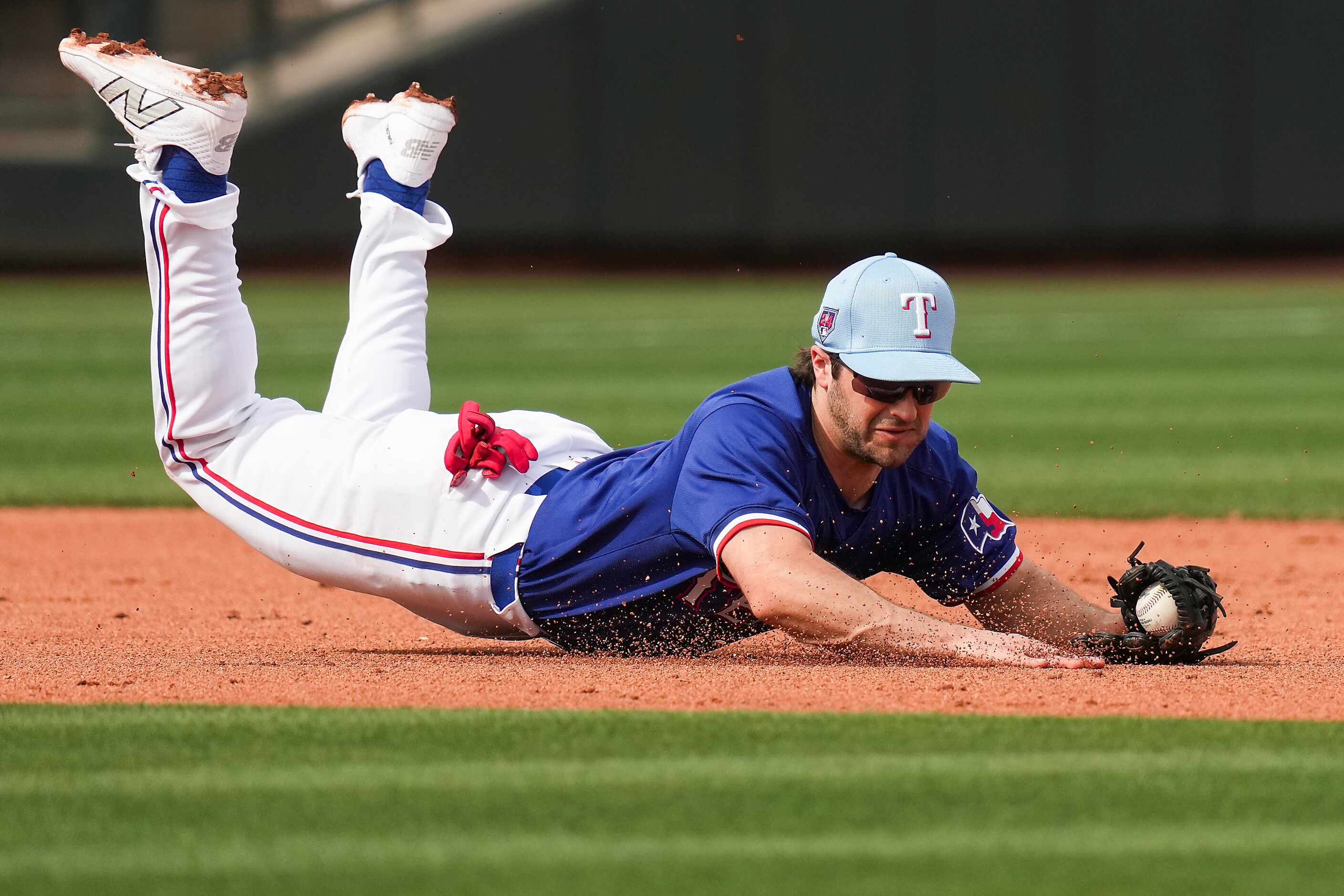 Texas Rangers third baseman Josh Smith makes a diving play on a grounder by the San...