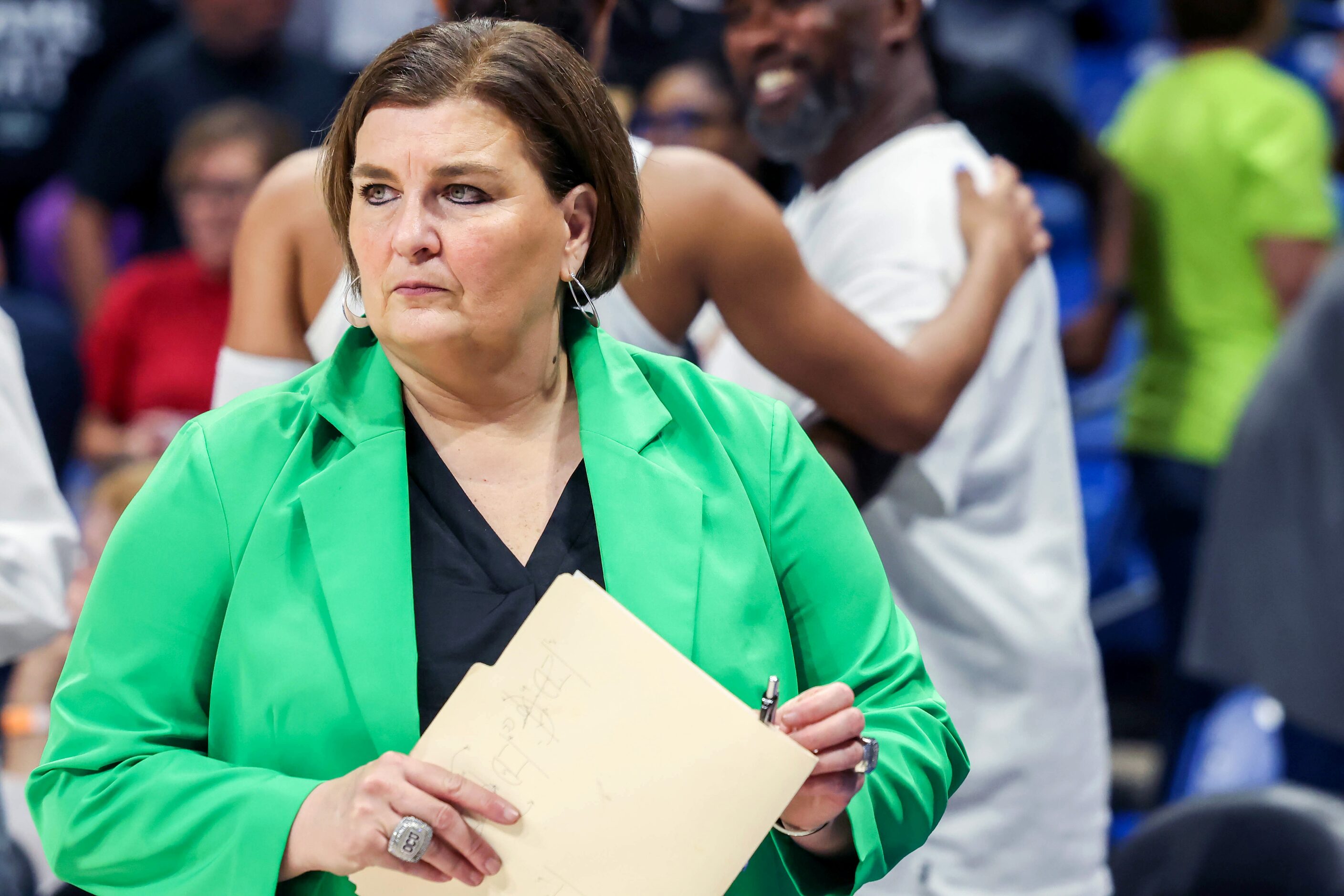 Dallas Wings coach Latricia Trammell looks out at the court after a loss to Connecticut Sun...