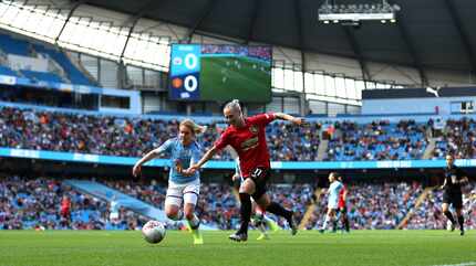 Manchester City's Aoife Mannion, left, and Manchester United's Leah Galton battle for the...
