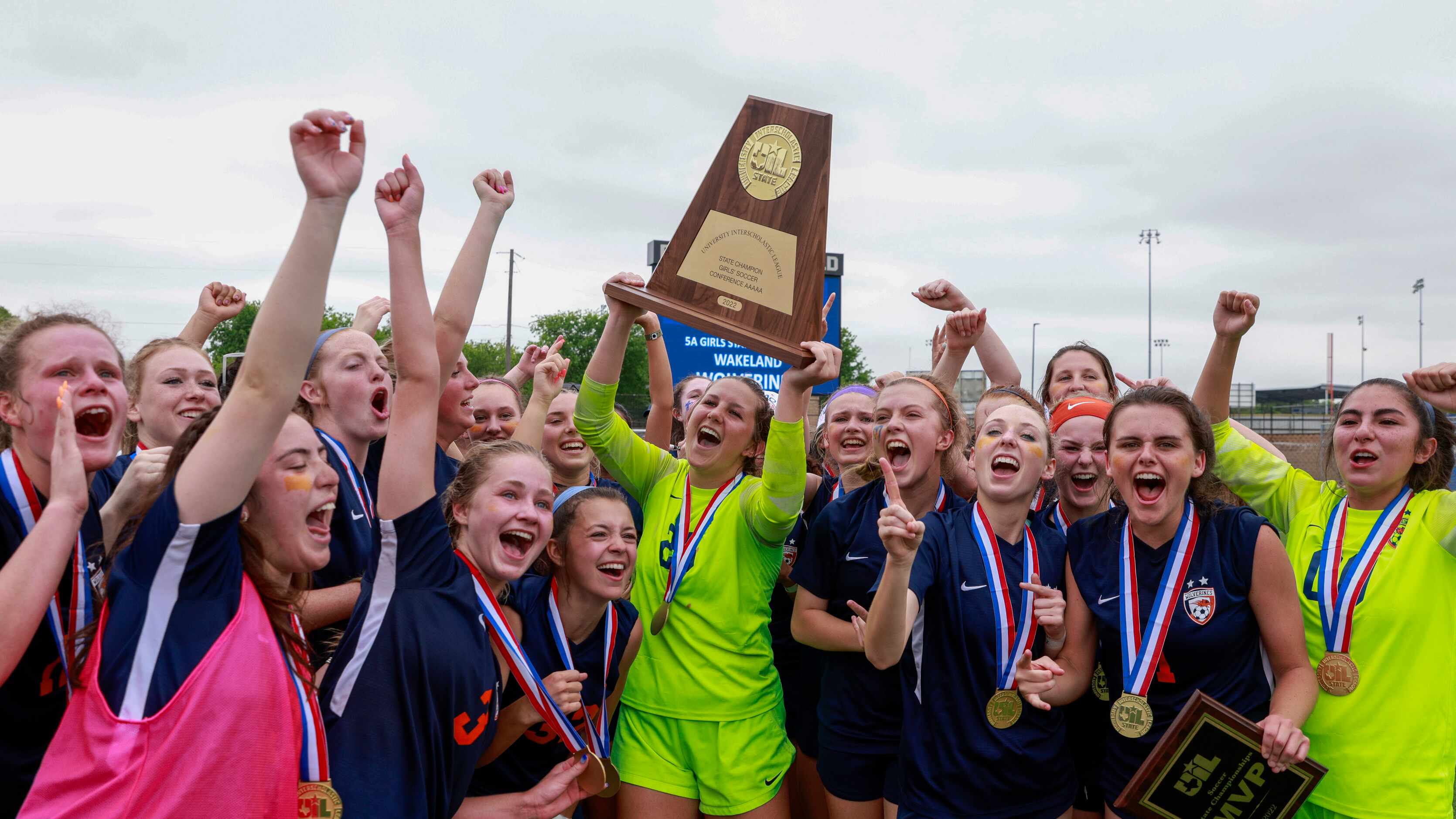 Frisco Wakeland goalkeeper Drew Stover (23) hoists the state championship trophy after...