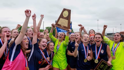 Frisco Wakeland goalkeeper Drew Stover (23) hoists the state championship trophy after...