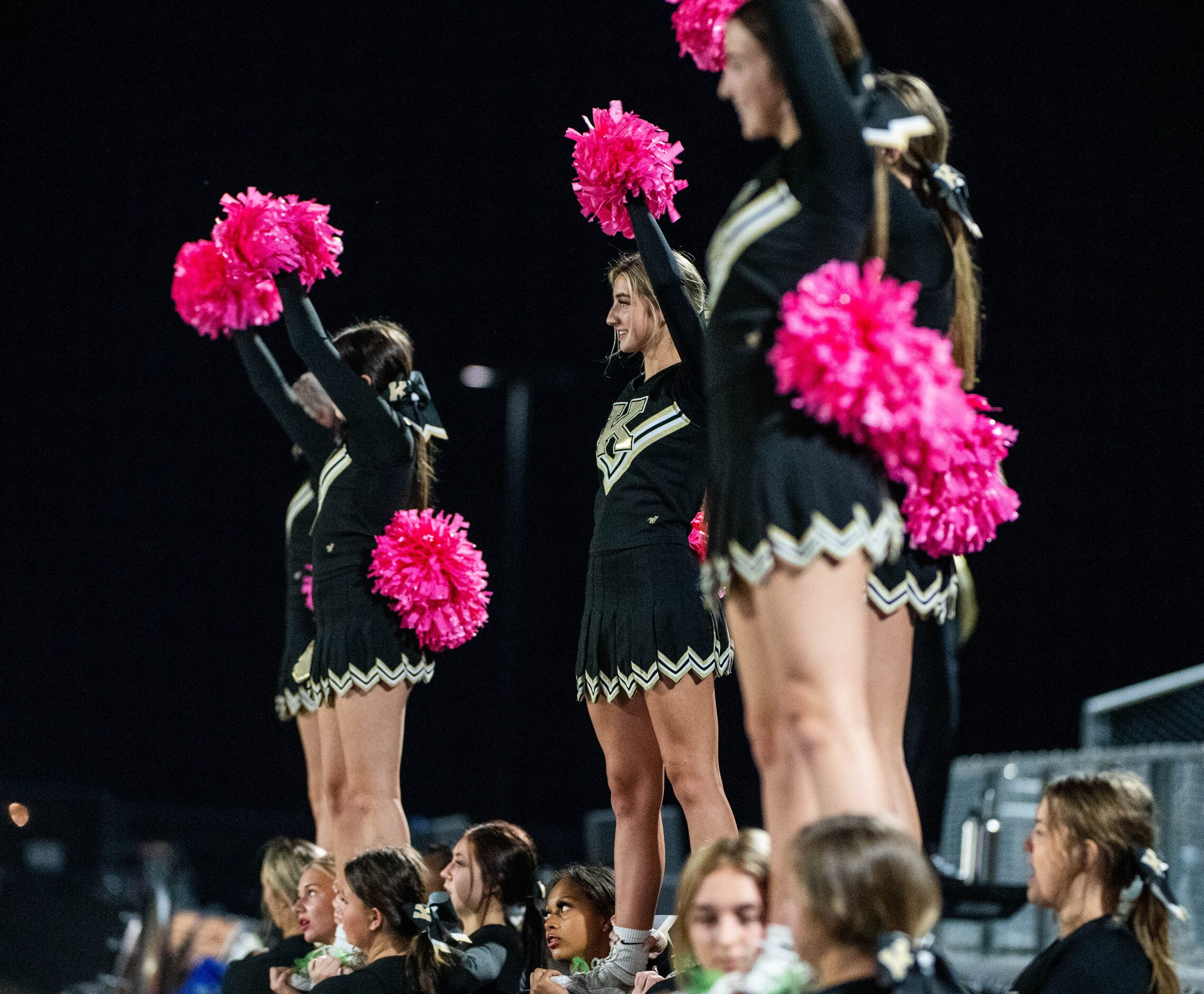 Kaufman cheerleaders perform in the first half during a high school football game against...