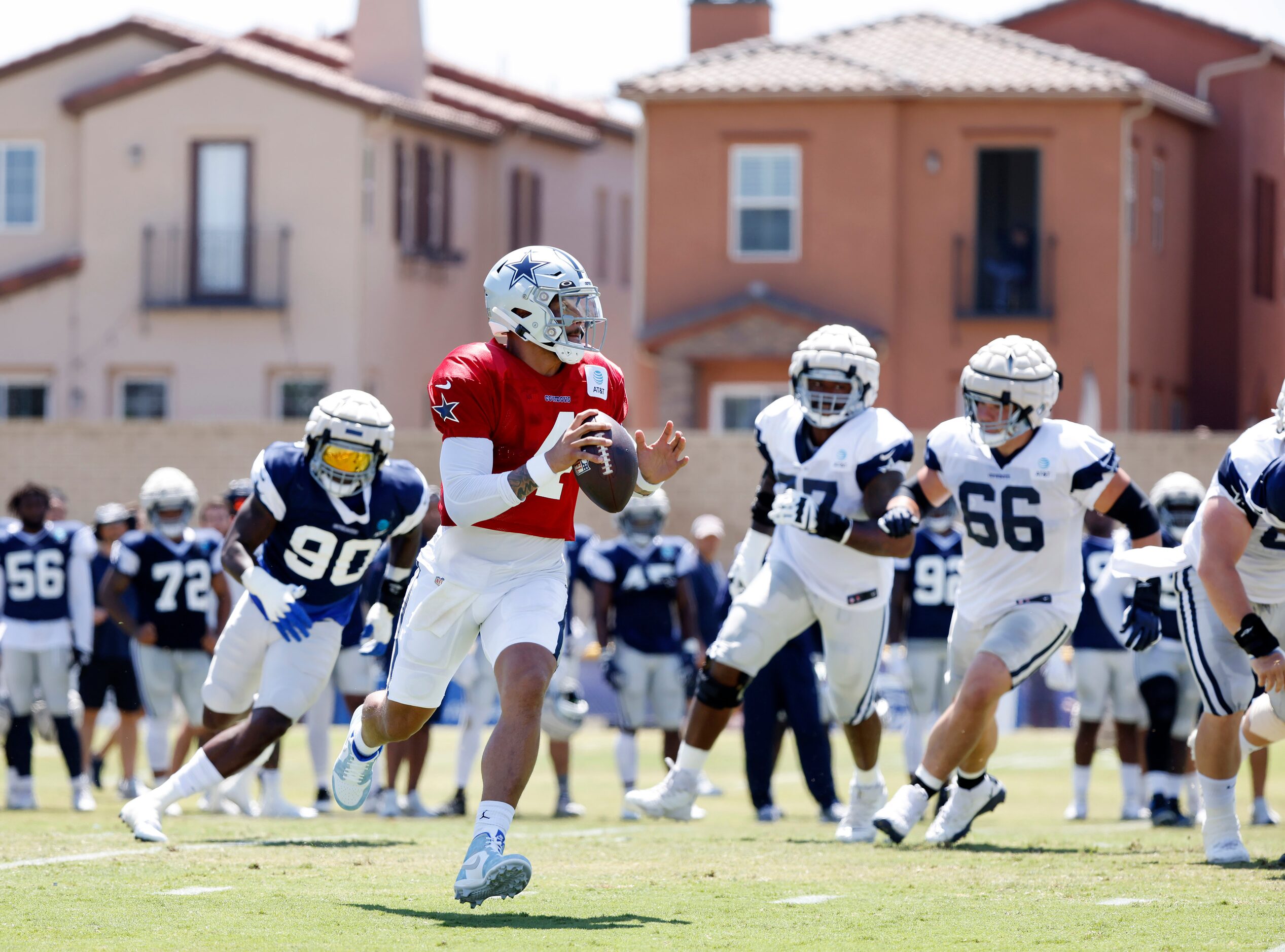 Dallas Cowboys quarterback Dak Prescott (4) rolls out before hitting tight end Dalton...