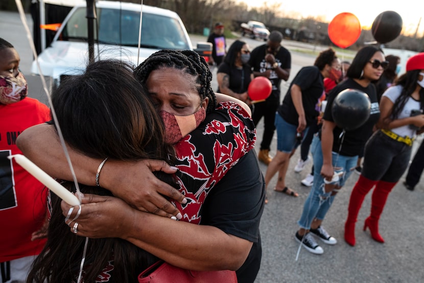 Candace Fleming (right) was hugged by friend Karith Foster as they mourned the death of...