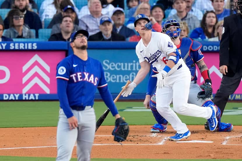 Los Angeles Dodgers' Will Smith, center, heads to first for a three-run home run as Texas...