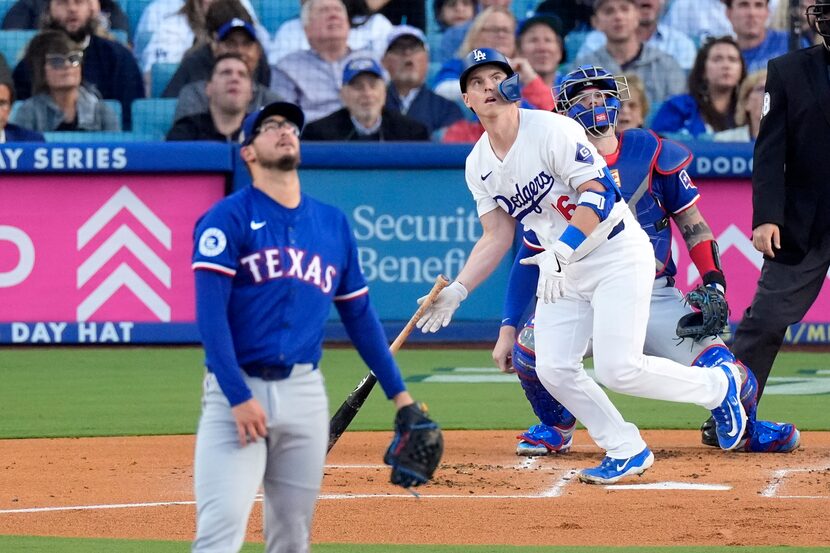 Los Angeles Dodgers' Will Smith, center, heads to first for a three-run home run as Texas...