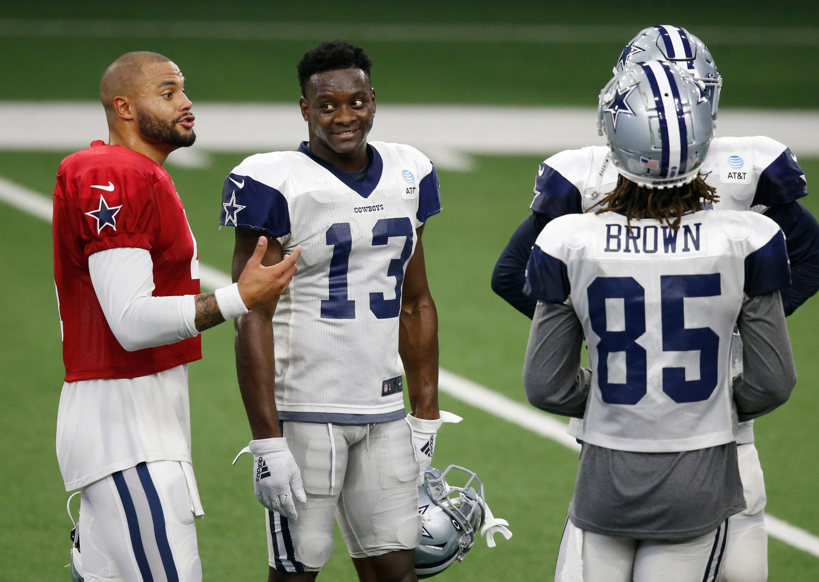 Dallas Cowboys wide receiver Michael Gallup (13) listens as Dallas Cowboys quarterback Dak...