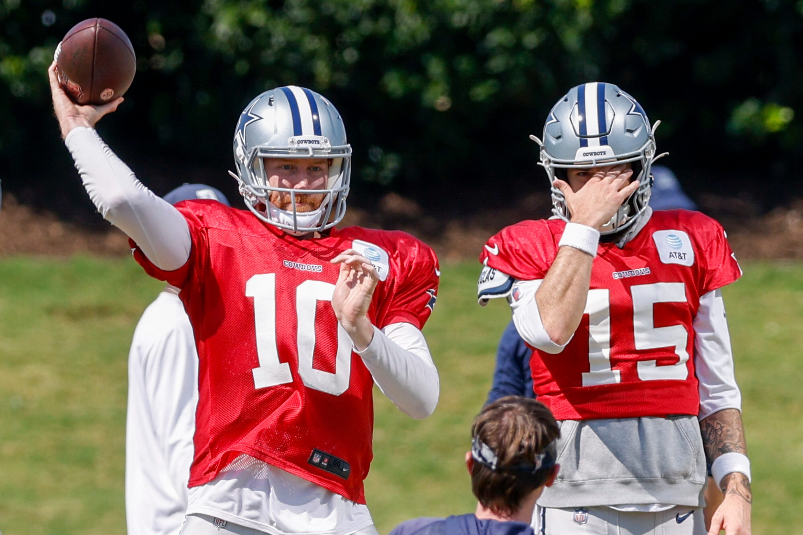 Dallas Cowboys quarterback Cooper Rush (10) throws a pass alongside quarterback Will Grier...