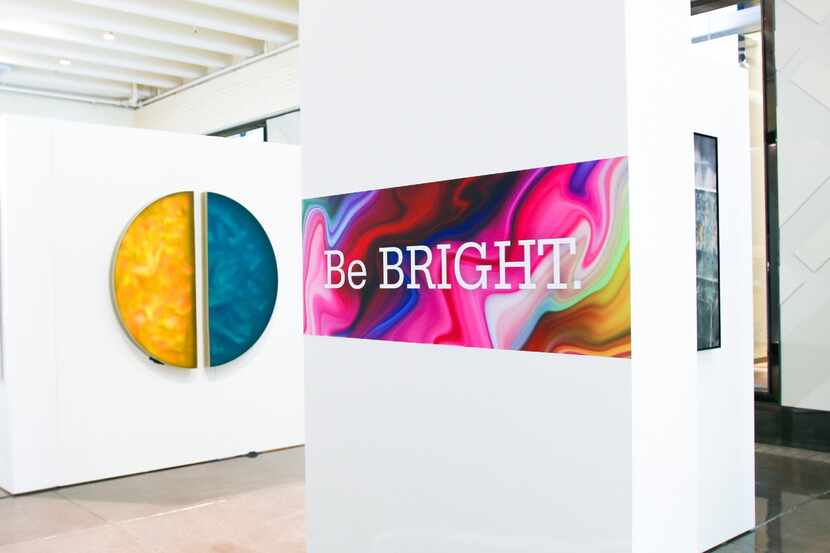 Art hangs on the wall at the DCAC art exhibit “Be Bold. Be Bright. Be Brave." at NorthPark...