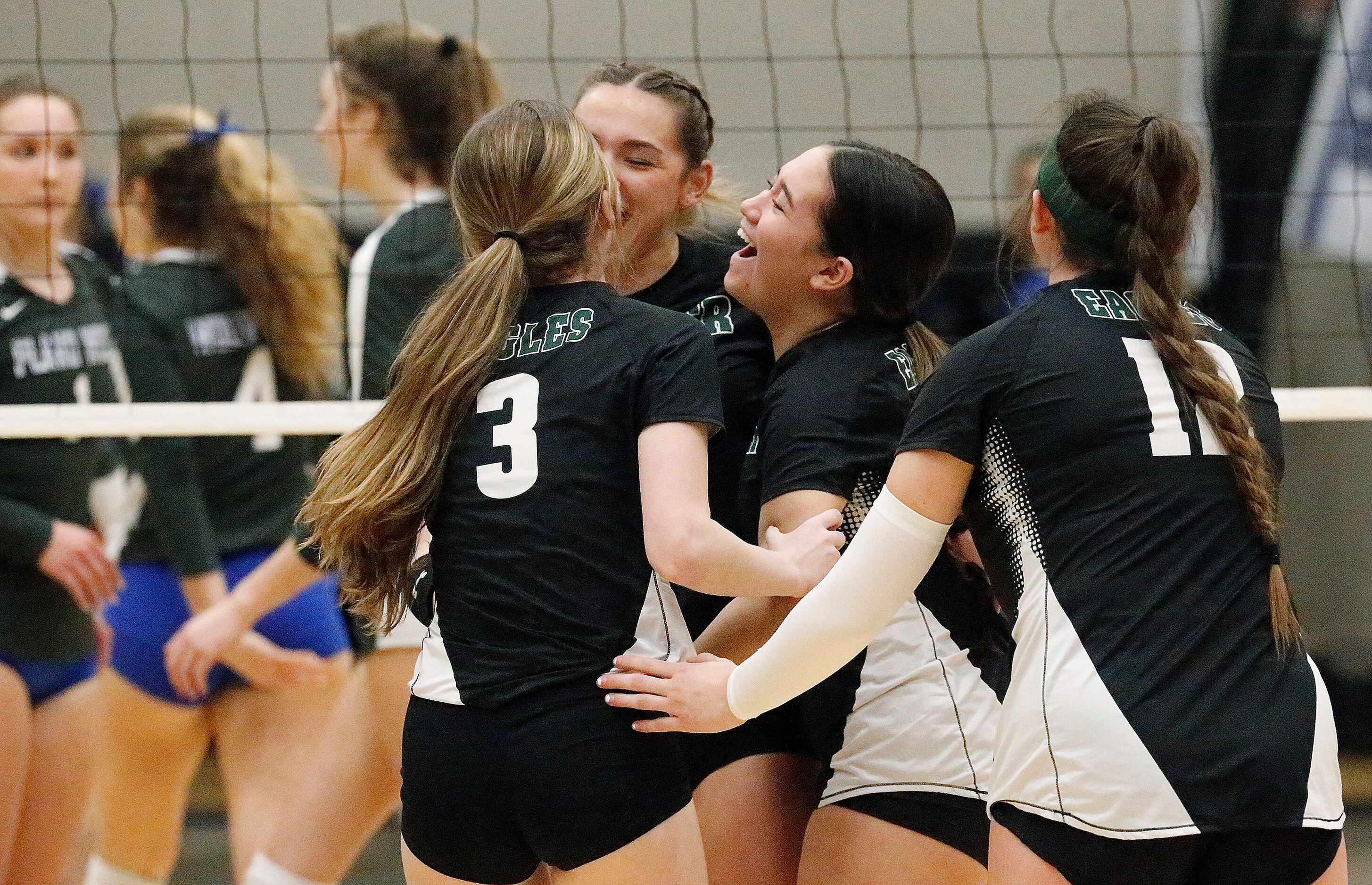 Prosper High School setter Callie Kieffer (1) celebrates a point with team mates during game...