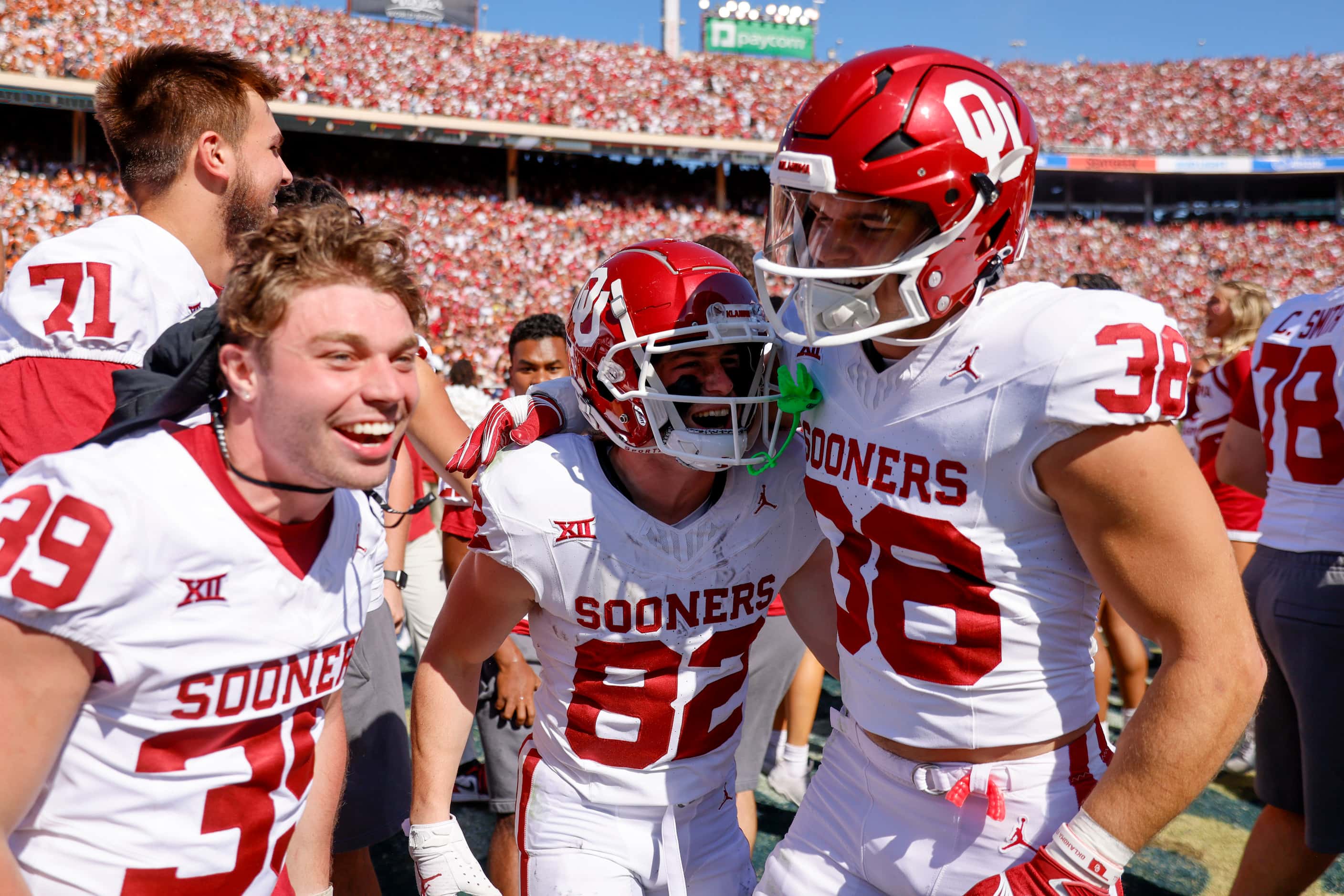 Oklahoma players cheer after defeating Texas during the Red River Rivalry at the Cotton...