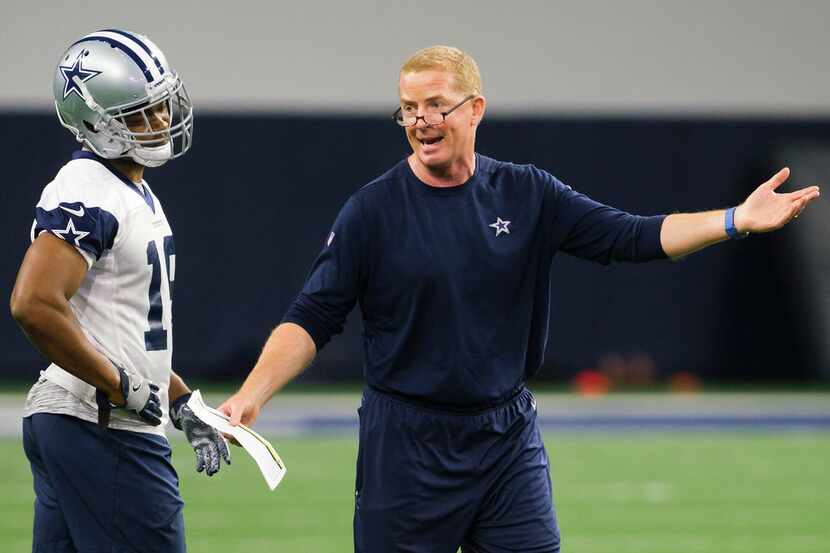 Dallas Cowboys head coach Jason Garrett makes a point as wide receiver Amari Cooper listens...