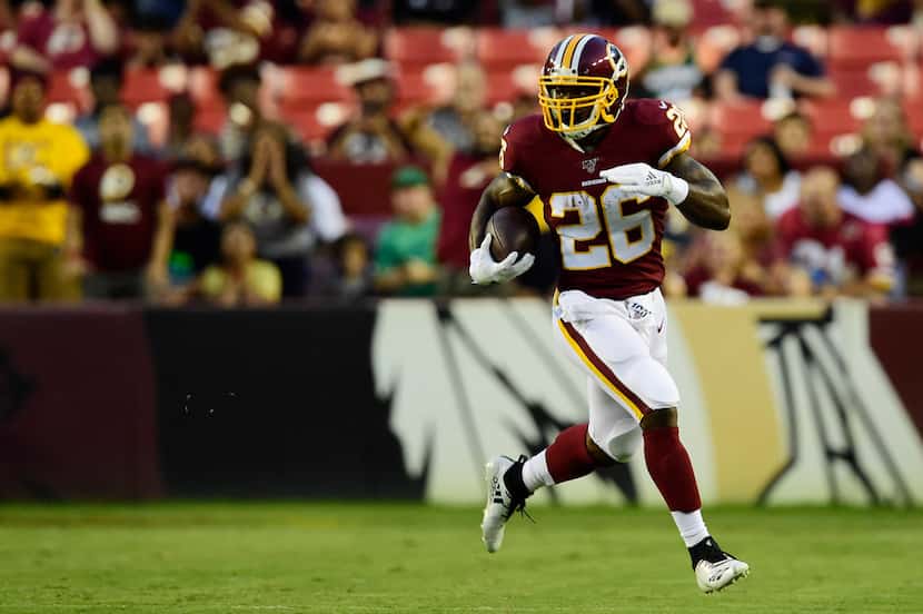 LANDOVER, MD - AUGUST 15: Adrian Peterson #26 of the Washington Redskins rushes with the...