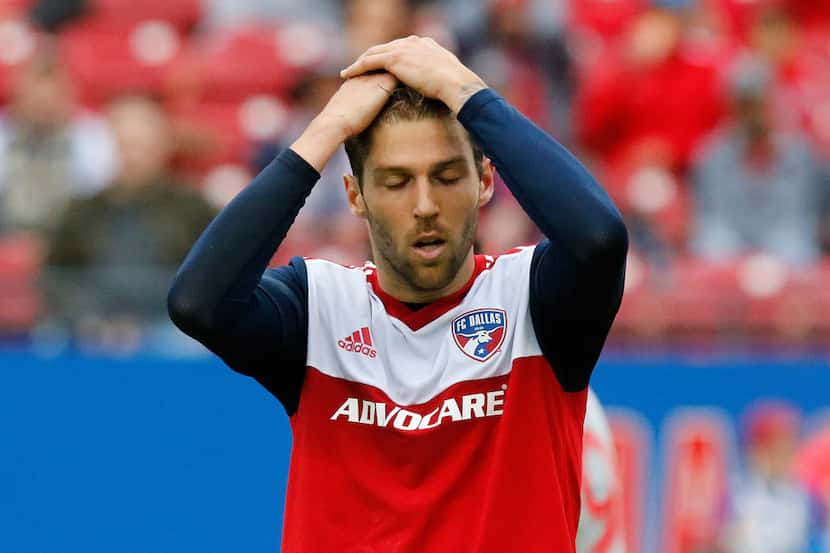 FC Dallas midfielder Ryan Hollingshead (12) holds his head in disbelief after missing a shot...