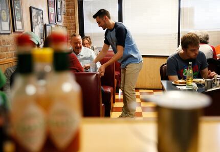 Max Sanchez, son of owner George Sanchez, takes an order at Gold Rush Cafe in East Dallas on...