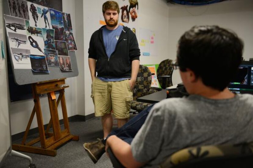 Guildhall students Austin Martin (center frame) and Nick Slay discuss their video game,...