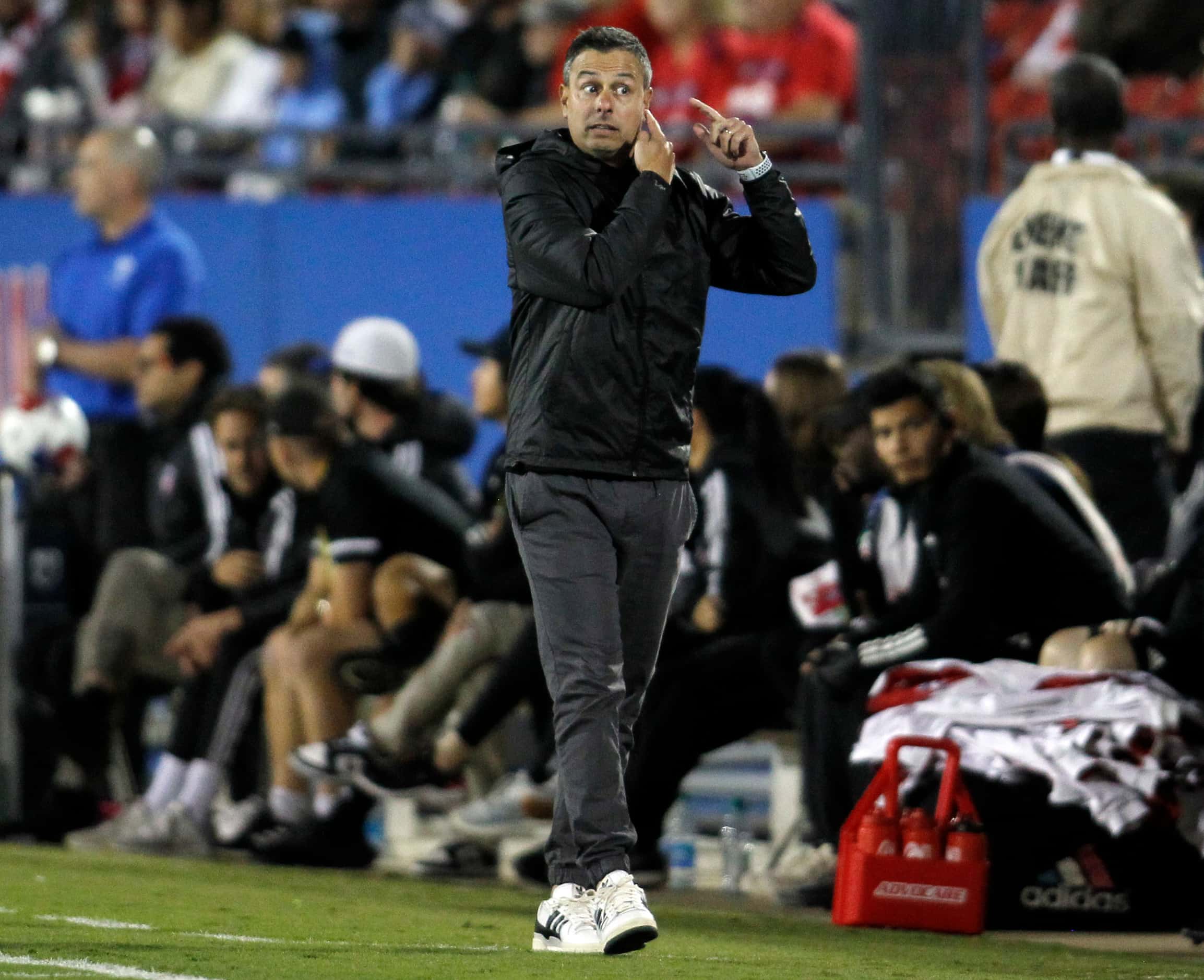 FC Dallas head coach Nico Esteves gestures along the team bench area during first half play...