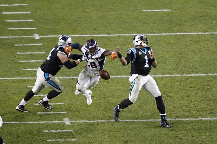 Denver Broncos linebacker Von Miller (58) strips the ball from Carolina Panthers quarterback...