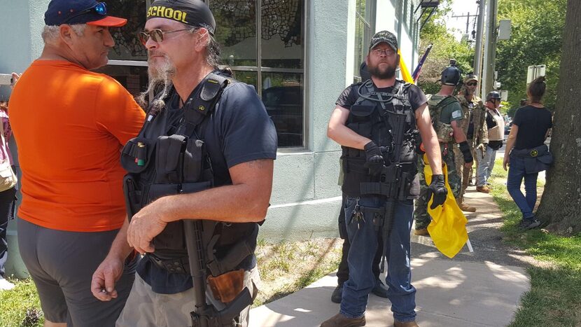 Unite the Right protesters stand outside Serhat Peker's restaurant in Charlottesville, Va....