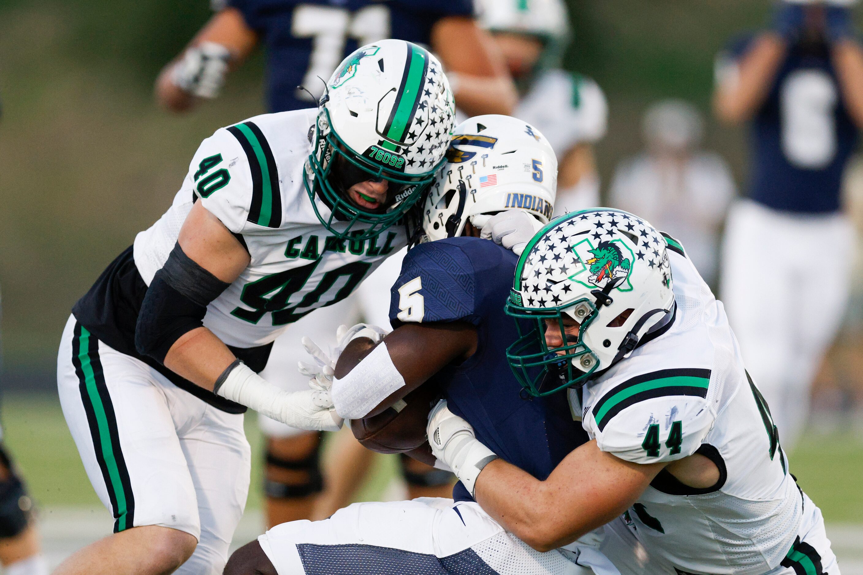 Southlake Carroll defensive linemen Julian Manero (40) and Dustan Mark (44) tackle Keller...