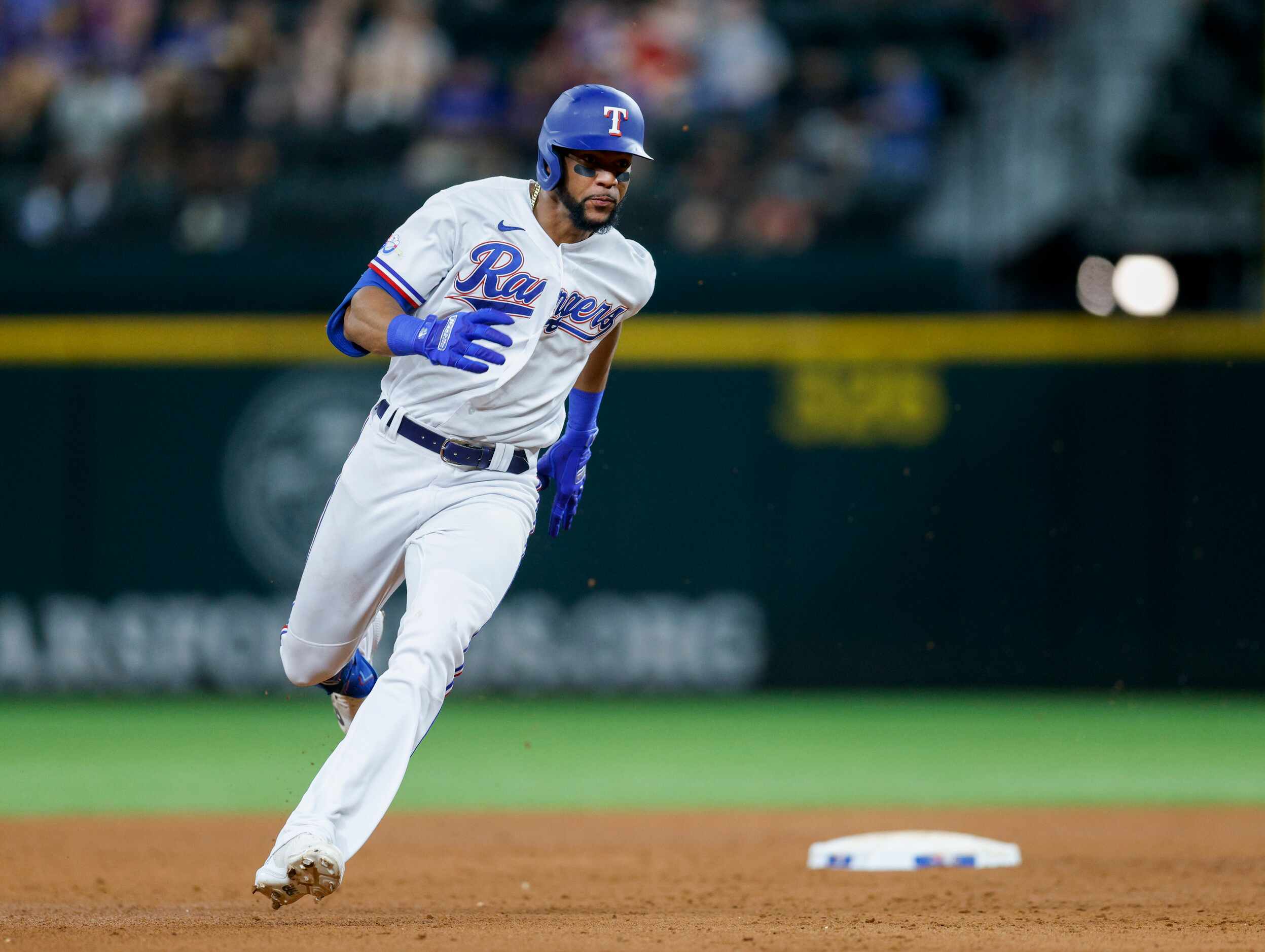 Texas Rangers center fielder Leody Taveras (3) rounds second base for a triple during the...