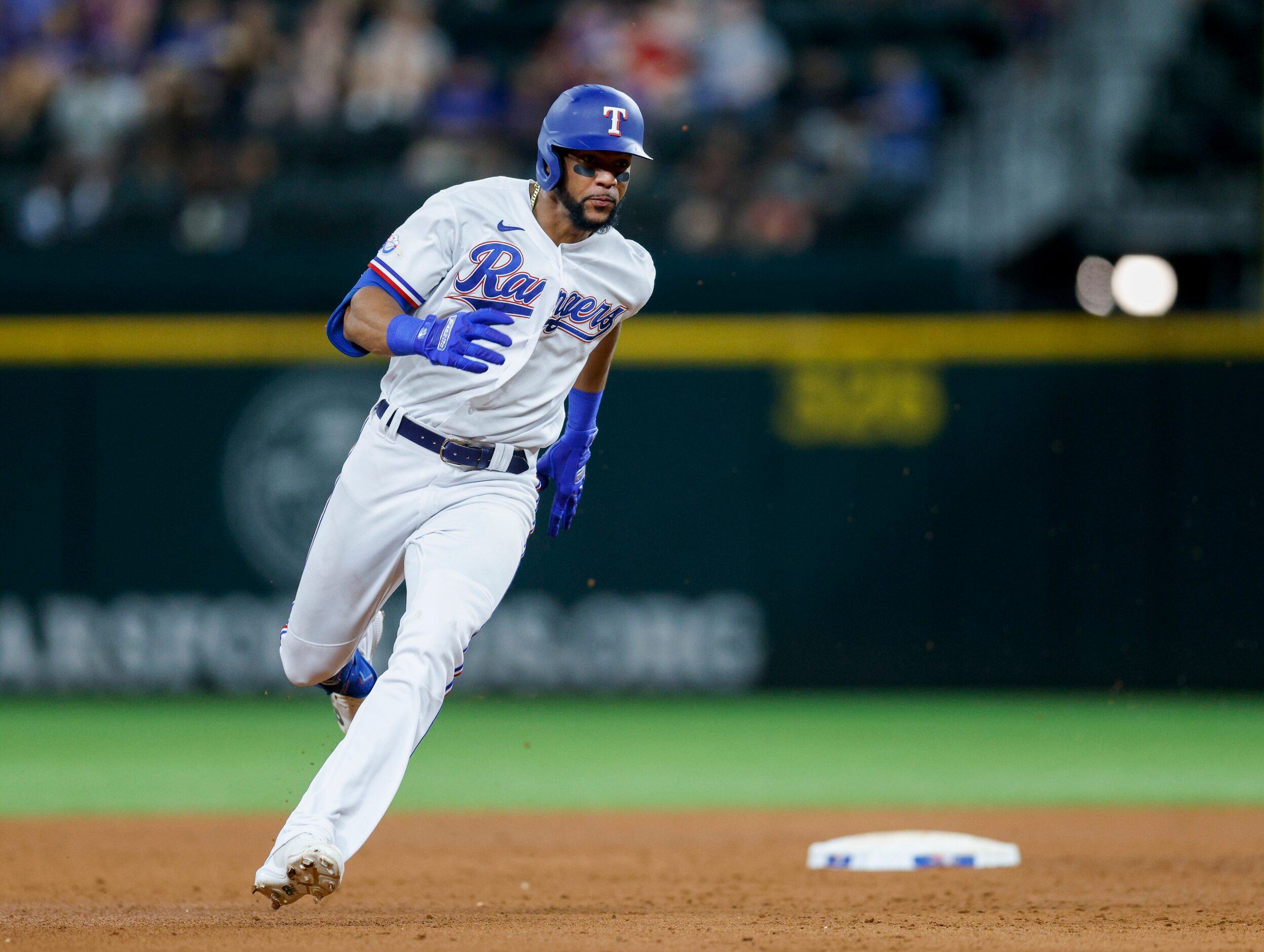 Texas Rangers center fielder Leody Taveras (3) rounds second base for a triple during the...