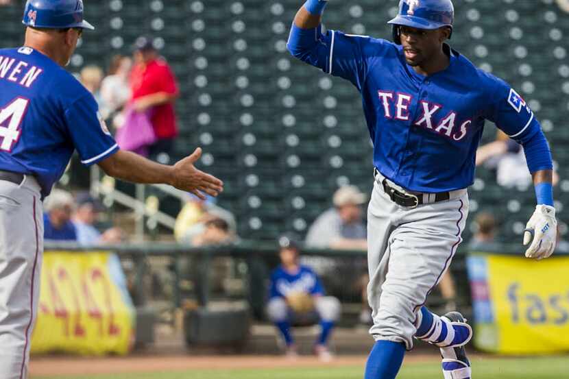 FILE - Texas Rangers outfielder James Jones gets a hand from Texas Rangers interim third...