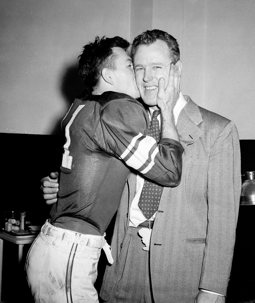 University of Oklahoma's Darrell Royal plants a resounding kiss on the cheek of head coach...