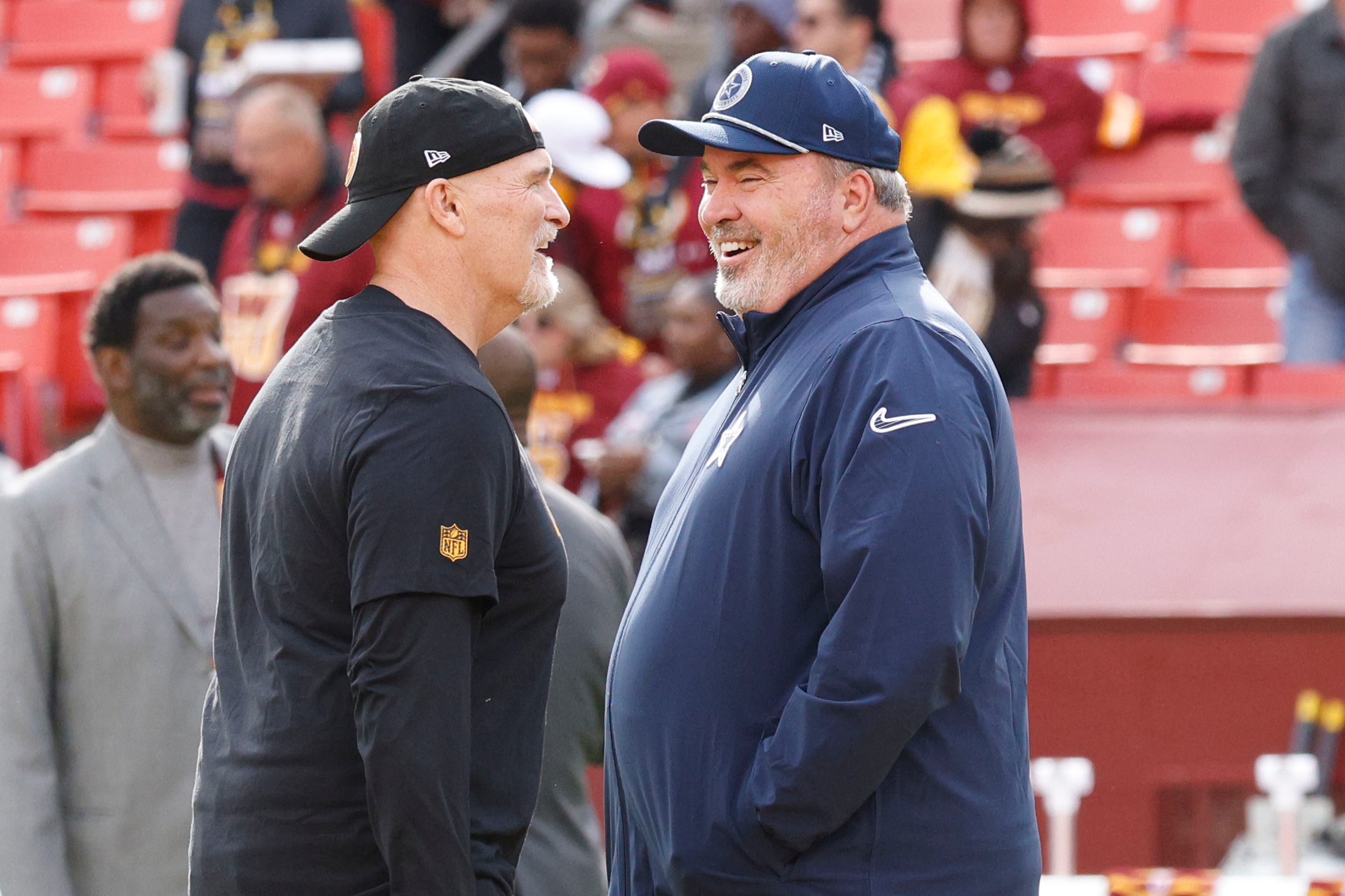 Washington Commanders head coach Dan Quinn  speaks to Dallas Cowboys head coach Mike...