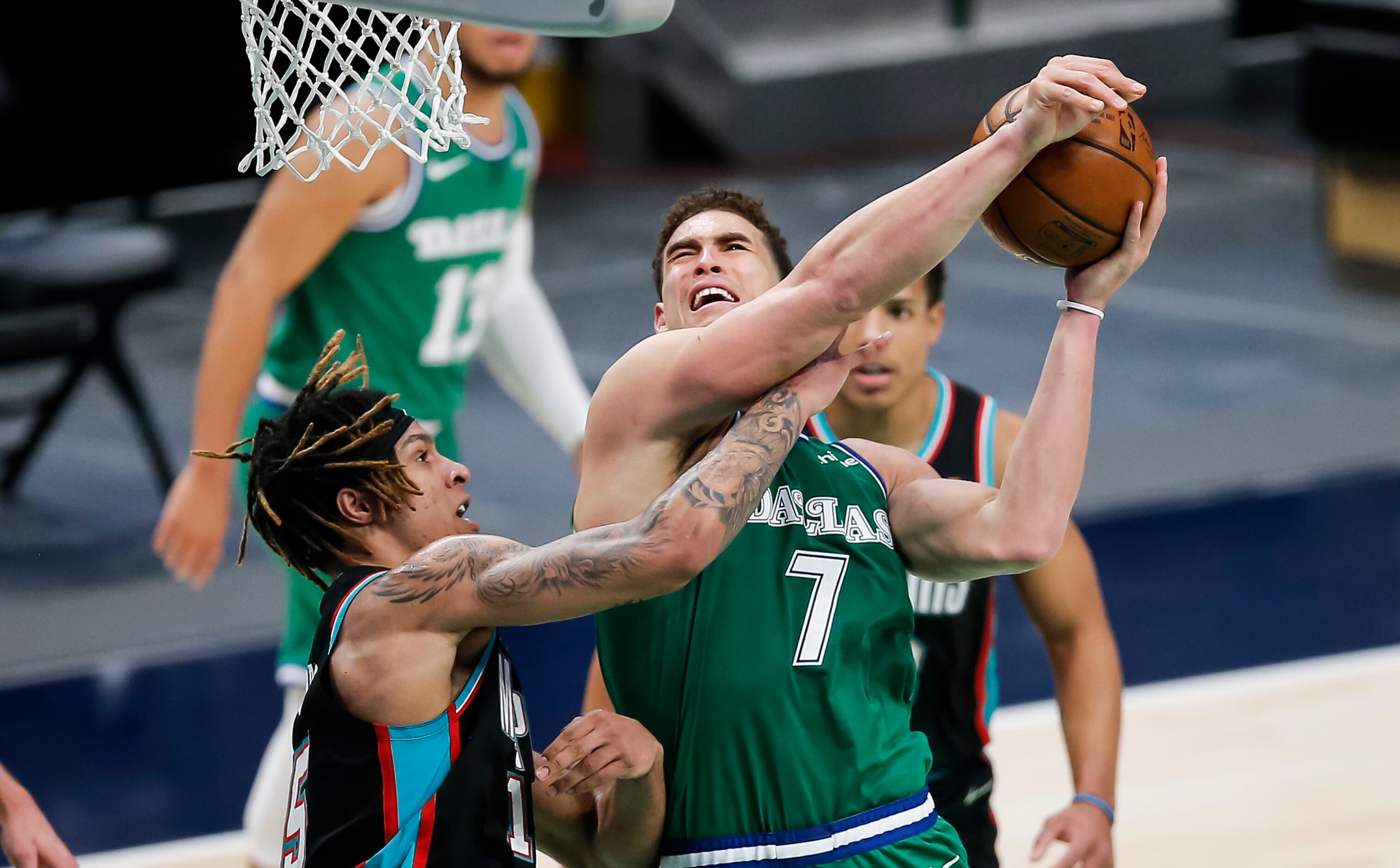 Dallas Mavericks forward Dwight Powell (7) attempts a shot as Memphis Grizzlies forward...