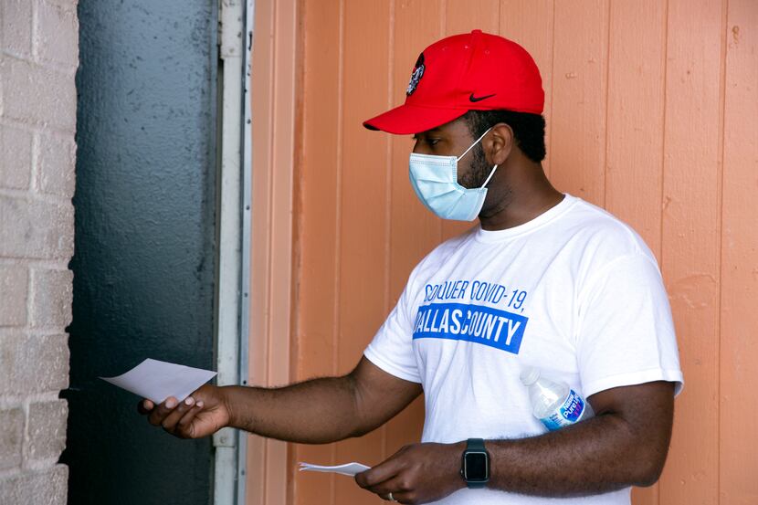 Jheison Romain (CQ) (center) of Dallas County Health and Human Services canvases Oak Cliff,...
