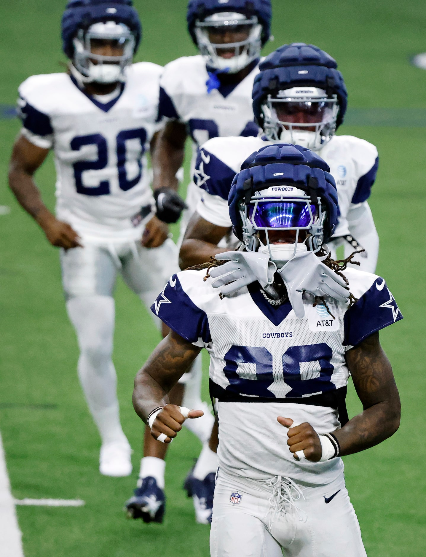 Dallas Cowboys wide receiver CeeDee Lamb (88) stretches with his teammates during a training...